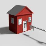 A red play house with a full size key aimed for the door