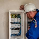 Electrician opening junction box