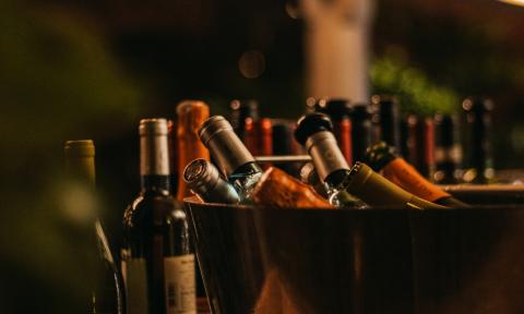 A container of wine bottles at an outdoor event