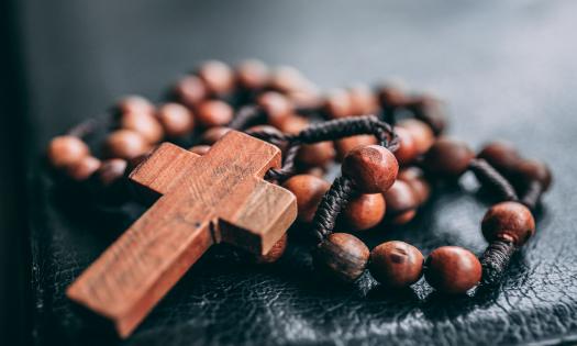 Prayer beads rest on a bible. 