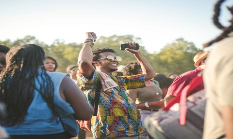 People celebrate at a concert.
