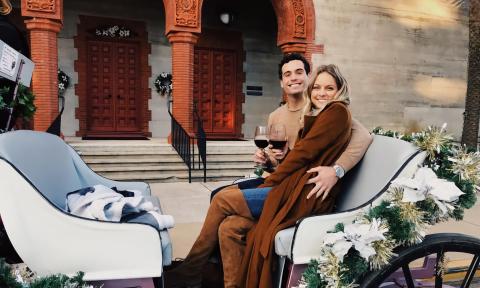 A Couple enjoying a private carriage ride during the holidays in St. Augustine