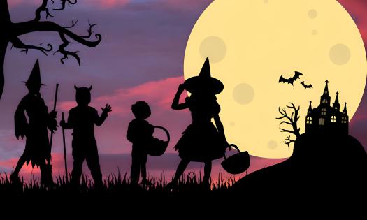 A graphic of a silhouette of four children in costume, trick or treating