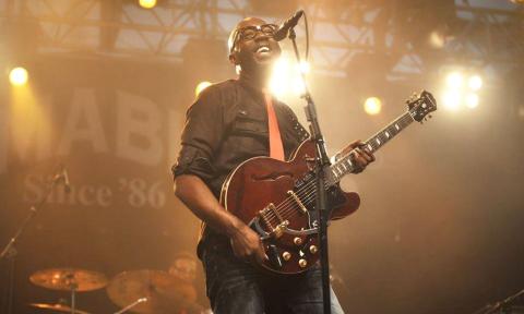 Mr. SIPP plays the guitar while singing the blues. 