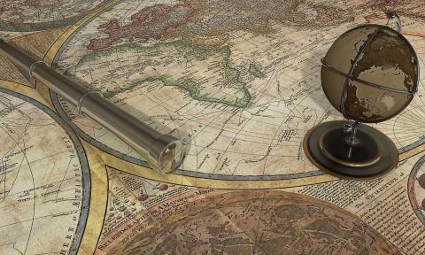 A public domain image of a world map with a globe and telescope on it
