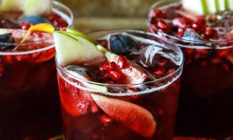 Three glasses of traditional red sangria, loaded with fruit