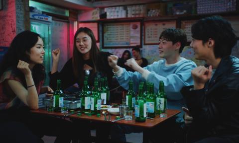 A group of young adults enjoy drinks at a Korean bar