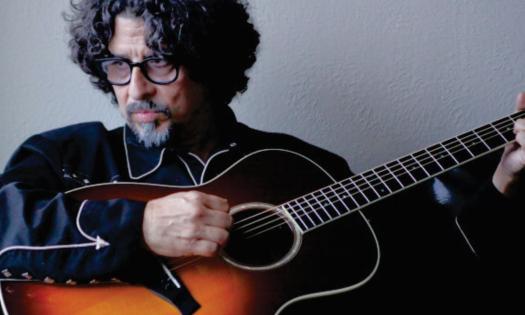 Musician and songwriter Dan Navarro poses with his acoustic guitar. 