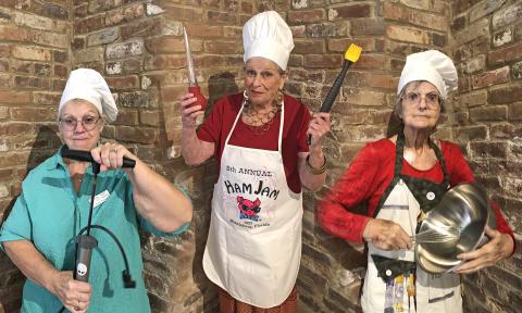 Three members of the Tale Tellers of St Augustine, in chef's hats and with kitchen tools