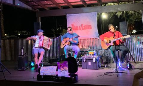 Dion & Collins, guitarists and vocalists, on stage with Robby O on the squeezebox
