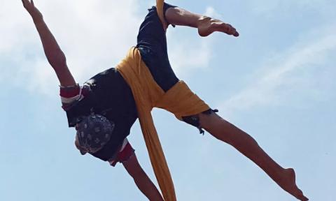 An aerialist practicing on silks