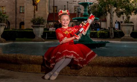The young dancer, Emily Laidler, with a nutcracker, in the garden at Lightner