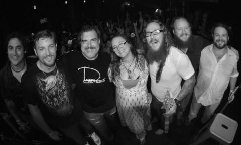 Bandmates from Melody Trucks smile and pose in a black and white photo.