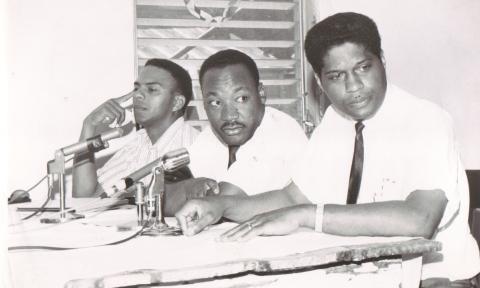 B&W Andrew Young, Dr. MLK Jr., and Dr. R. B. Hayling at a press conference 1964.