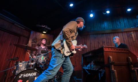 Bandmates from The Koch Marshall Trio perform live on stage. 