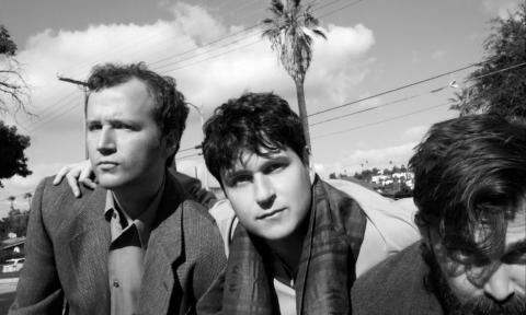 Bandmates from Vampire Weekend pose in a black and white photograph. 