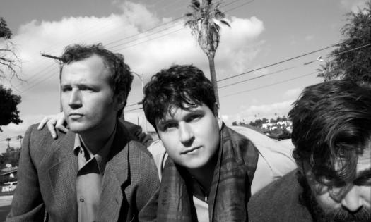 Bandmates from Vampire Weekend pose in a black and white photograph. 