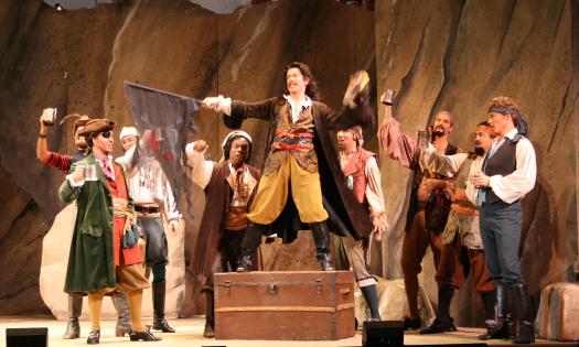 The male members of the cast of First Coast Opera's Pirates of Penzance on stage