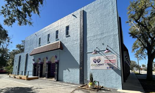The exterior of Limelight Theatre, with sky blue paint and purple trim