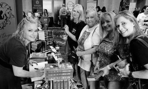Lynessa Layne signs her book at a book conference