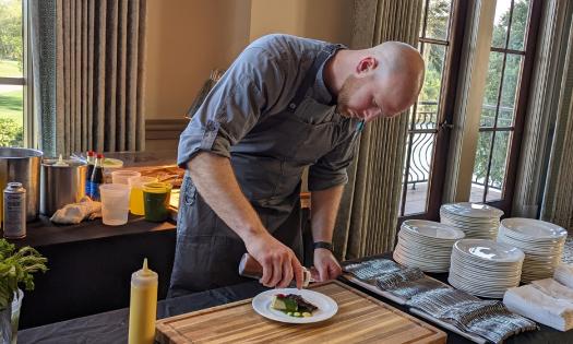  A chef at Taste of Golf fundraiser for First Tee prepares a small plate gourmet bite