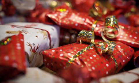 Small wrapped holiday packages in red, white, and gold