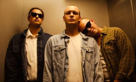 Three band members in an elevator
