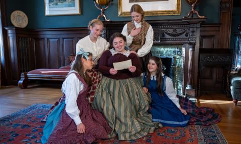 The cast of "Little Women" huddled together