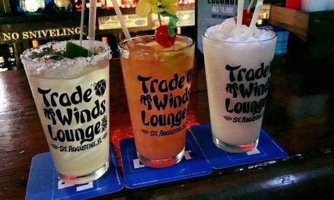 Three tropical drinks from in glasses from Trade Winds Tropical Lounge