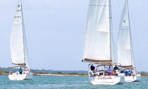 Three sailboats racing on the Tolomato River