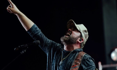 Lee Brice sings and performs on stage.