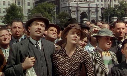 A crowd of people in a scene from "This Happy Breed"