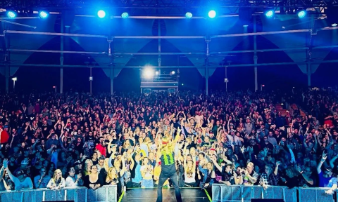 Bret Michaels lifts his hand high as he rocks the stage before a crowd of devoted fans.