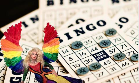 A drag queen with bingo sheets