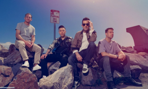 Bandmates from O.A.R. pose on a cluster of jagged rocks.