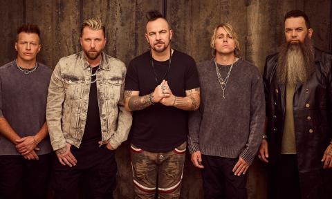 Bandmates from Three Days Grace pose in front of a brown backdrop.