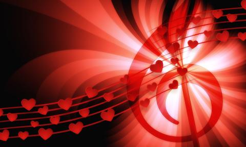 A g-clef and music staff with hearts