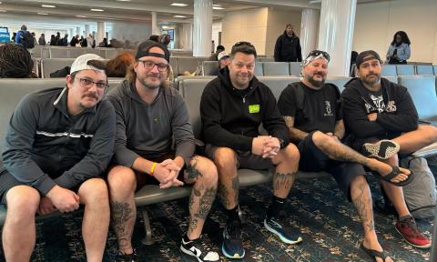 The band called the Supervillains waiting in an airport for a flight to St. Thomas gigs