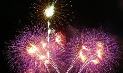 A firework display of various colors and designs