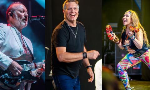 Bandmates from Men at Work perform on stage.