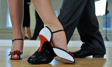A woman in heels and a man in dancing shoes
