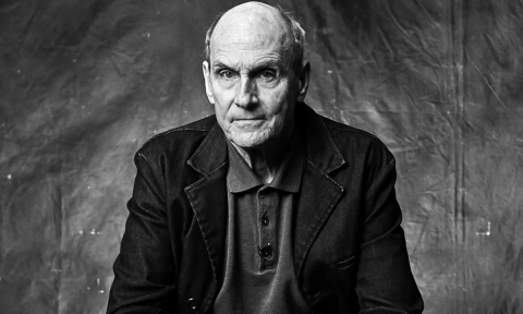 James Taylor poses in a black and white photograph for fans. 