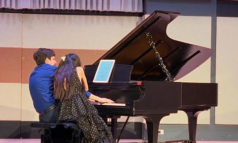 Echo Piano Duo performing on one piano in a four-hand compostion