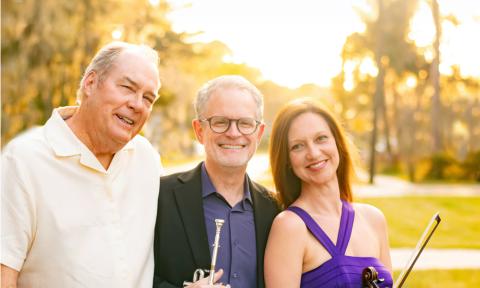 Three musicians, members of the Powell trio, standing outside