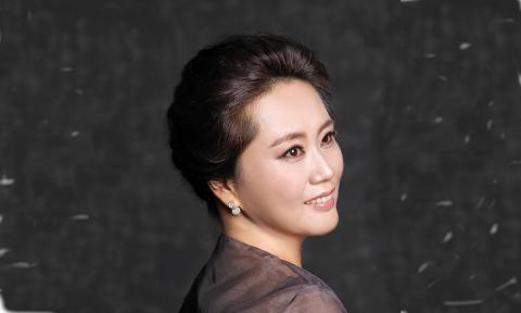 Sunny K. Choi, soprano, against a black and grey background