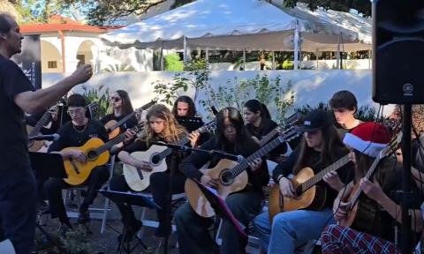 Young guitarists performing in a classical guitar ensemble