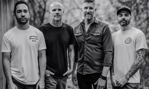 Bandmates from Exhaustra pose in a black and white photograph.