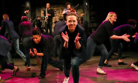 Dancers in Chicago Tap Theater on a red stage in black 