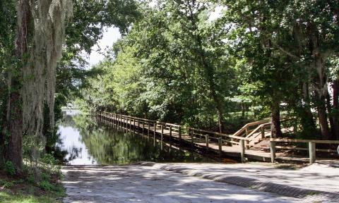 The boat ramp at Trout Creek Park is surrounded by mature trees