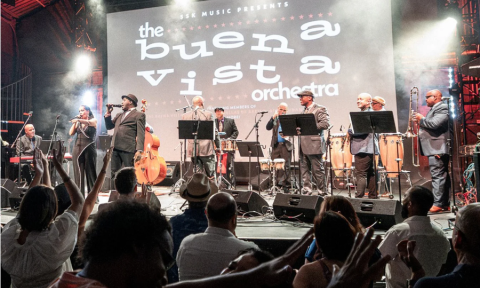 Bandmates from Buena Vista Orchestra perform on stage.